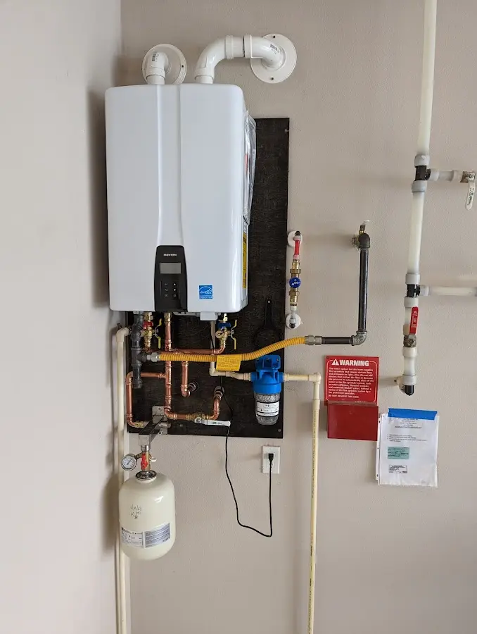 Professional plumber installing copper piping in a Anderson Creek home